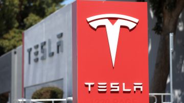 FREMONT, CALIFORNIA - APRIL 20: A sign is posted in front of a Tesla service center on April 20, 2022 in Fremont, California. Tesla reported first quarter earnings that far exceeded analyst expectations with revenue of $18.76 billion compared to expectations of $17.80 billion. (Photo by Justin Sullivan/Getty Images)