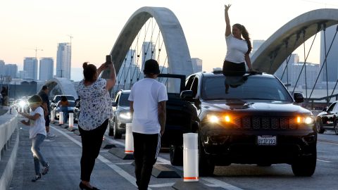 LOS ANGELES, CALIFORNIA - JULY 11: A person poses for a photo on the newly-opened 6th Street Viaduct, connecting Boyle Heights with downtown L.A., on July 11, 2022 in Los Angeles, California. The $588-million project which opened over the weekend took six years to finish and is designed to withstand a magnitude 9.0 earthquake. The original viaduct was constructed in 1932 and demolished in 2016 after it was determined to be seismically-deficient. (Photo by Mario Tama/Getty Images)