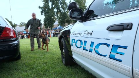 A K9 dog is lead to a police vehicel during a display by the Monterey Park police department at a "Night Out" activity on August 1, 2017 in Monterey Park, California One of hundreds of such activites expected to take place across the country for National Night Out, which began over 30 years ago with a call for people to hold small public gatherings in a take-back-the-streets show of community pride which, over the years, has grown to include block parties, parades, movie screenings and picnics. / AFP PHOTO / FREDERIC J. BROWN (Photo credit should read FREDERIC J. BROWN/AFP via Getty Images)