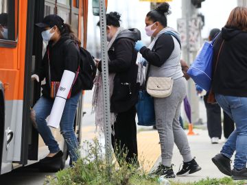 LOS ANGELES, CALIFORNIA - APRIL 06: People board a bus wearing face masks amid the coronavirus pandemic on April 6, 2020 in south Los Angeles, California. Nearly 11,000 people have died in the U.S. from COVID-19. (Photo by Mario Tama/Getty Images)