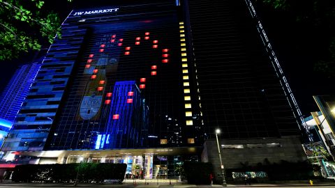 LOS ANGELES, - APRIL 16: A view of LA Live and JW Marriott Hotel displaying a heart on April 16, 2020 in Downtown Los Angeles, United States. Landmarks and buildings across the nation are displaying blue lights to show support for health care workers and first responders on the front lines of the COVID-19 pandemic. (Photo by Frazer Harrison/Getty Images)