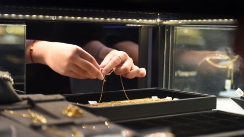 A staff member arranges jewellery at a gold shop in Hanoi on July 29, 2020. (Photo by Nhac NGUYEN / AFP) (Photo by NHAC NGUYEN/AFP via Getty Images)