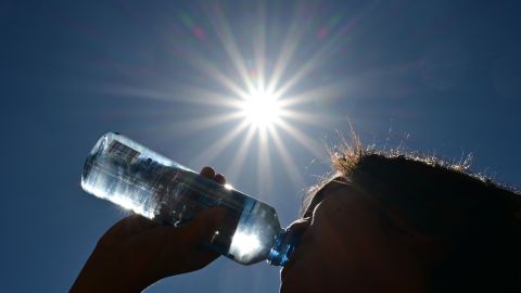 A child sips water from a bottle under a scorching sun on August 30, 2022 in Los Angeles, California. - Forecasters said the mercury could reach as high as 112 Fahrenheit (44 Celsius) in the densely populated Los Angeles suburbs in the next week as a heat dome settles in over parts of California, Nevada and Arizona. (Photo by Frederic J. BROWN / AFP) (Photo by FREDERIC J. BROWN/AFP via Getty Images)