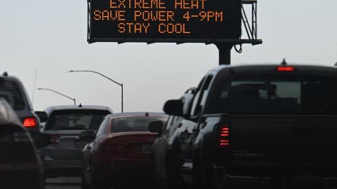 TOPSHOT - Vehicles drive past a sign on the 110 Freeway warning of extreme heat and urging energy conservation during a heat wave in downtown Los Angeles, California on September 2, 2022. - A "dangerous" heat wave has taken hold of the southwestern US. Forecasters said the mercury could reach as high as 112 Fahrenheit (44 Celsius) in the densely populated Los Angeles suburbs as a heat dome settles in over parts of California, Nevada and Arizona. (Photo by Patrick T. FALLON / AFP) (Photo by PATRICK T. FALLON/AFP via Getty Images)