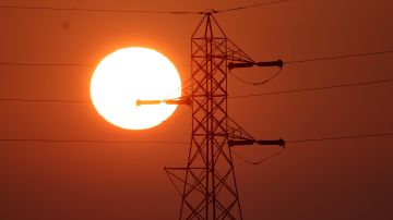 SUISUN CITY, CALIFORNIA - JANUARY 26: The sun rises behind a tower carrying electrical lines on January 26, 2022 in Suisun City, California. The Department of Homeland Security (DHS) is warning that domestic extremists have been developing specific plans to target electrical infrastructure in the United States. (Photo by Justin Sullivan/Getty Images)