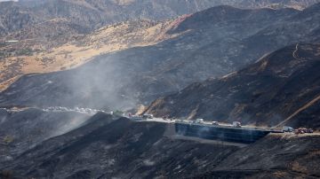 CASTAIC, CALIFORNIA - SEPTEMBER 1: Vehicles travel single file on a reopened section of the 5 freeway which was closed yesterday as the Route Fire burned on September 1, 2022 near Castaic, California. Some evacuation orders have been lifted while the brush fire has scorched more than 5,000 acres amid a brutal heat wave in Southern California. The National Weather Service issued an Excessive Heat Warning for most of Southern California through Labor Day. Climate models almost unanimously predict that heat waves will become more intense and frequent as the planet continues to warm. (Photo by Mario Tama/Getty Images)