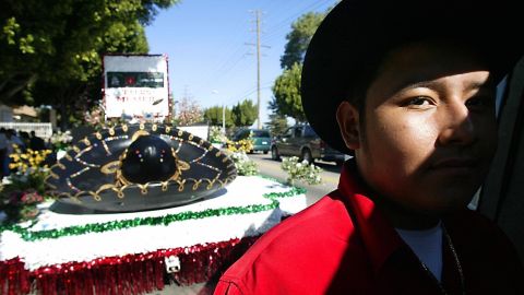 A man waits to board his float from "Tacos Mexico" in East Los Angeles, CA while he awaits the beginning of the parade celebrating the independence of Mexico, 07 September 2003. People with Latin American origins living in California are estimated to number some 10 million, or one in every three residents in the state. Although this number continues to grow, the number of registered voters is only 14 percent of the electorate. Experts are predicting the Latino voter will be pivotal to the success of the recall election in which California Governor Gray Davis will be required to submit to evaluation his second term. More than 100 office-seekers are officially registered as candidates--among them actor Arnold Schwarzenegger, adult film actress Mary Carey, Lt Governor Cruz Bustmante and political commentator Arianna Huffington. AFP PHOTO/HECTOR MATA (Photo credit should read HECTOR MATA/AFP via Getty Images)