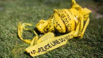 A bundle of police crime scene tape is left on front of the 7-eleven shop in Santa Ana, California on August 08, 2019 where a security guard was fatally stabbed. - Police said the suspect, Zachary Castaneda, a 33-year-old resident of Garden Grove used multiple knives or machetes in the attacks that started yesterday afternoon. (Photo by Apu GOMES / AFP) (Photo by APU GOMES/AFP via Getty Images)