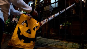WASHINGTON, DC - OCTOBER 31: PVC pipe is used to give trick-or-treaters candy on October 31, 2020 in Washington, DC. Many people found unique ways to social distance and adhere to CDC guidelines while celebrating Halloween this year. (Photo by Stefani Reynolds/Getty Images)