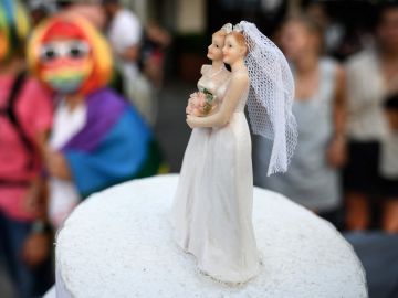 A wedding cake is displayed as members of lesbian, gay, bisexual, transgender, intersex and queer (LGBTIQ) community take part in the Zurich Pride on September 4, 2021 ahead of a nationwide votation on the marriage for all. - Swiss citizens are due to vote on September 26, 2021 to determine whether the right to marry should be extended to same-sex couples or not. (Photo by FABRICE COFFRINI / AFP) (Photo by FABRICE COFFRINI/AFP via Getty Images)