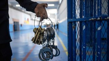 A guard carries keys and handcuffs at the prison of Kenitra, in the coastal city of the same name, near the Moroccan capital Rabat, on August 31, 2021. - After passing through the North African kingdom's Moussalaha ("Reconciliation") programme, some prisoners are hoping for a reprieve. The programme, launched in 2015 and led by Morocco's DGAPR prison service with several partner organisations, aims to help terror detainees who are willing to question their beliefs. (Photo by FADEL SENNA / AFP) (Photo by FADEL SENNA/AFP via Getty Images)