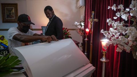 Asylum seekers from Haiti mourn during a funeral service for two Haitian men who died in the city on May 5th in Tijuana, Baja California state, Mexico, on June 2, 2022. - The funeral organized by Haitian Bridge Alliance was open to the Haitian community and the media to raise awareness of racism that black migrants face in Mexico. According to the Alliance press on May 5, two Haitian migrants died in Tijuana on separate events, Jocelyn Anselme, 34, was murdered during a robbery and Calory Archange, 30, died from a heart attack after medical care was denied to him. (Photo by Guillermo Arias / AFP) (Photo by GUILLERMO ARIAS/AFP via Getty Images)