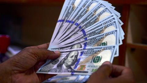 A foreign currency dealer counts US dollar notes at a currency market in Karachi on July 19, 2022. (Photo by Asif HASSAN / AFP) (Photo by ASIF HASSAN/AFP via Getty Images)