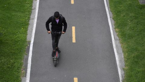 A man rides a electric scooter during the day without car and motorcycle, which seeks to improve air quality, in Bogota on September 22, 2022. - Bogota restricted car and motorcycle traffic for one day to reduce pollution in the Colombian capital, one of the largest metropolises in Latin America. (Photo by Raul ARBOLEDA / AFP) (Photo by RAUL ARBOLEDA/AFP via Getty Images)