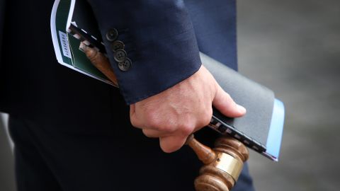 SYDNEY, AUSTRALIA - MAY 08: Auctioneer Jesse Davidson holds a gavel during an auction of a residential property in the suburb of Strathfield on May 08, 2021 in Sydney, Australia. Property prices continue to rise across Australia with house prices up almost 27 percent compared to five years ago. Record low interest rates have also seen a surge in home loan applications in the last year. (Photo by Lisa Maree Williams/Getty Images)