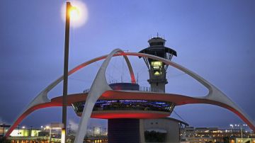 LOS ANGELES, CA - APRIL 10: The old futuristic Encounter restaurant and the Los Angeles Internationl Airport (LAX) control tower are located at the heart of the U-shaped terminal on April 10, 2004 in Los Angeles, California. Los Angeles International Airport has unveiled a $9 billion plan, backed by LA Mayor Jim Hahn, to attempt to transform itself into the nation's highest-security airport. Changes would require passengers to pass through two screening checkpoints, equipped with the latest explosive-detection technologies, as casino-style security cameras would keep watch over them. Curbside pickup and drop-off of passengers at the terminal would be banned. Travellers would have to be let off a mile from the airport where they would go through security screening then ride a "people mover" train to the airport. (Photo by David McNew/Getty Images)
