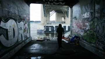 LOS ANGELES, CA - APRIL 21: A homeless man who goes by the name "Pepper" walks through a tunnel at the place where he sleeps along the graffiti-covered walls that line the banks of the Los Angeles River on April 21, 2006 in Los Angeles, California. Yesterday, officials unveiled plans for a 40-acre park along the concrete waterfront, an early step in the "Los Angeles River Revitalization Master Plan" to restore most of the 32-mile concrete-lined waterway to its natural state creating what an official called an "emerald necklace" of parks and riparian habitat. Throughout most of the year, the river's small, unthreatening but massive flooding, which occurs during winter storms, prompted engineers of the 20th century to encase the river in concrete. Environmentalists have long wanted to restore parts of the river. (Photo by David McNew/Getty Images)
