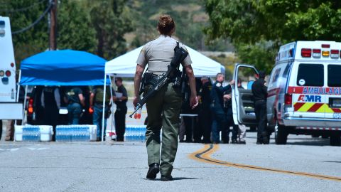 An armed law enforcement personnel walks outside a closed-off North Park Elementary School in San Bernardino, California on April 10, 2017, following a shooting at the elementary school in San Bernardino. A gunman opened fire at North Park Elementary School killing one woman and wounding two students before turning the gun on himself, police said. The students were airlifted to a local hospital where their conditions were described as critical. Students at North Park Elementary School -- which has around 500 students between kindergarten and sixth grade -- were transported to Cajon CHigh School following the shooting. / AFP PHOTO / FREDERIC J. BROWN (Photo credit should read FREDERIC J. BROWN/AFP via Getty Images)