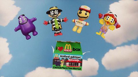 Imagen de los cuatro personajes de McDonalds y de una cajita feliz en un fondo de nubes.