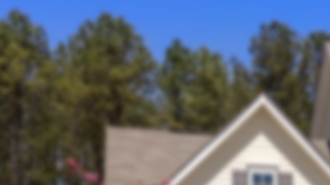 Una imagen de una casa y de un letrero de venta en su jardín.