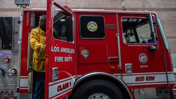 Cameron Richards, a probationary firefighter, leaves a fire truck in a morning training of the LAFD Station No9 team at Skid Row on April 12, 2020 in downtown Los Angeles, California. - One of the busiest fire station in the country , LA Fire Station 9 is on the front lines of California's homeless crisis e Coronavirus pandemic. (Photo by Apu GOMES / AFP) (Photo by APU GOMES/AFP via Getty Images)