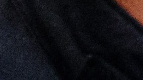 Defendant Rabieh R (R) covers his face as a judicial officer opens his handcuffs in the courtroom of the Higher Regional Court in Dresden, eastern Germany on August 30, 2022 prior to a hearing in the trial over a jewellery heist on the Green Vault (Gruenes Gewoelbe) museum in Dresden's Royal Palace in November 2019. - Six members of a notorious criminal gang stand trial in Germany over the spectacular heist in which 18th-century jewels were snatched from the state museum in Dresden. They are accused of gang robbery and arson after the brazen night raid on The Green Vault museum on November 25, 2019. (Photo by JENS SCHLUETER / POOL / AFP) (Photo by JENS SCHLUETER/POOL/AFP via Getty Images)