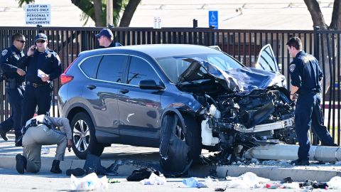 TOPSHOT - Law enforcement personnel take a closer look at the destruction of an SUV involved in critically injuring nearly two dozen deputy recruits in a Los Angeles County Sheriff's Department training academy class in Whittier, California on November 16, 2022. - At last five trainee sheriff's deputies were badly hurt when a car rammed into a group of cadets jogging in Los Angeles, US media reported Wednesday. (Photo by Frederic J. BROWN / AFP) (Photo by FREDERIC J. BROWN/AFP via Getty Images)