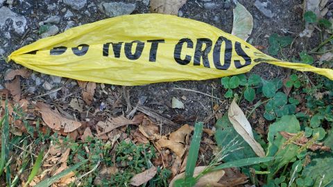 CHICAGO, ILLINOIS - AUGUST 16: Remnants of police crime scene tape remain near the site where two young girls were shot after leaving their grandmother's home yesterday on August 16, 2021 in Chicago, Illinois. The two girls were shot as their mother was buckling them in her vehicle. Seven-year-old Serenity Broughton died from her injuries. Broughton's 6-year-old sister Aubrey was seriously wounded and remains in the hospital following the shooting, which occurred on August 15. (Photo by Scott Olson/Getty Images)