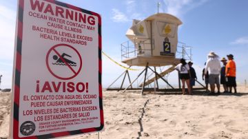 HUNTINGTON BEACH, CALIFORNIA - OCTOBER 03: A warning sign is posted near oil washed up on Huntington State Beach after a 126,000-gallon oil spill from an offshore oil platform on October 3, 2021 in Huntington Beach, California. The spill forced the closure of the popular Great Pacific Airshow with authorities urging people to avoid beaches in the vicinity. (Photo by Mario Tama/Getty Images)