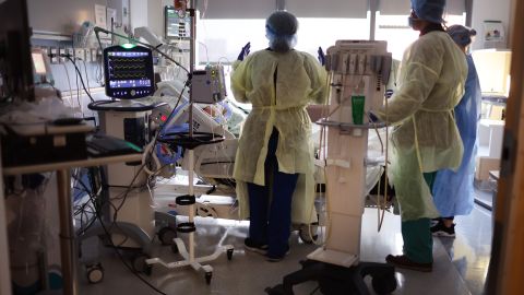 CHICAGO, ILLINOIS - JANUARY 31: Respiratory Therapist Annette Johnson (L) helps to treat a COVID-19 patient in the ICU at Rush University Medial Center on January 31, 2022 in Chicago, Illinois. Respiratory therapists work with physicians and nurses to help patients restore and maintain normal lung capacity and blood/oxygen levels. After two years, the COVID-19 pandemic has contributed to an estimated 1,000,000 American deaths. (Photo by Scott Olson/Getty Images)