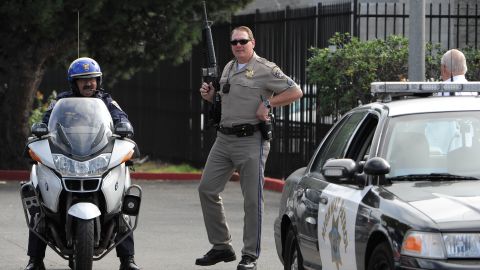 SAN DIEGO, CA - FEBRUARY 7: California Highway Patrol officers stand guard as police officers search for suspect, former LAPD officer Christopher Jordan Dorner, at a hotel in the Point Loma area February 7, 2013 in San Diego, California. A manhunt is underway for Dorner, who is suspected of shooting at police officers in the Los Angeles area. (Photo by Denis Poroy/Getty Images)