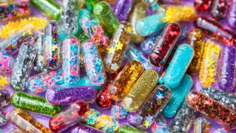 Closeup of glittery shimmery shiny pills capsule background