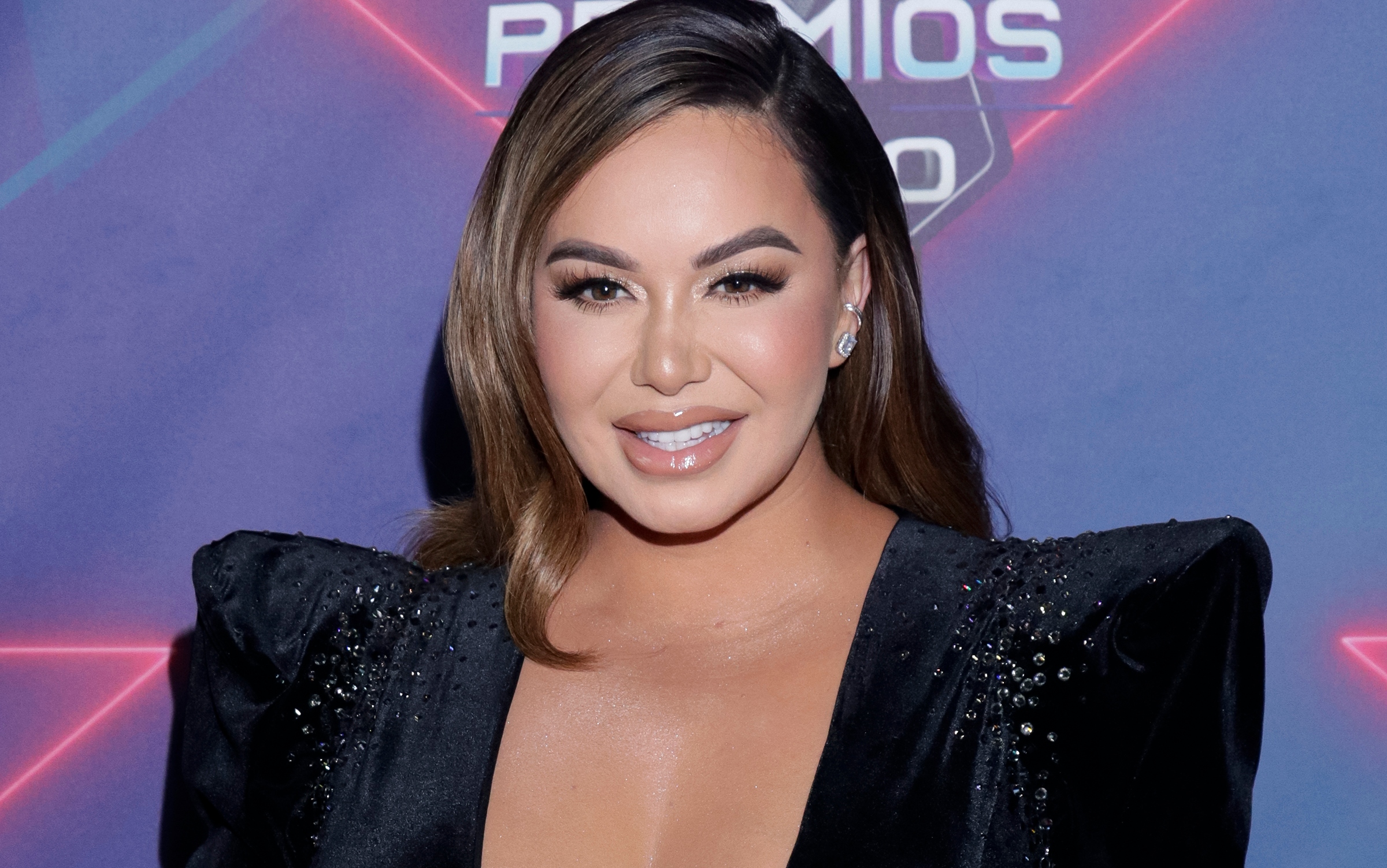 Chiquis Rivera Shows Off Her Curves On Stage Wearing A Tight Black Jumpsuit With Openings 