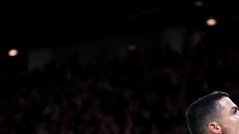 Imagen de Cristiano Ronaldo mientras levanta uno de sus brazos para señalar a las gradas.