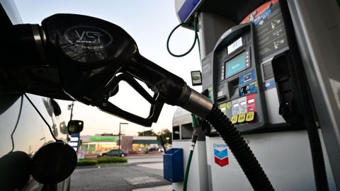Imagen de una bomba de gasolina y de un auto que está cargando combustible.