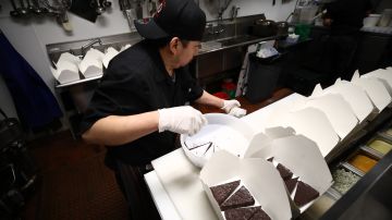 SAN FRANCISCO, CALIFORNIA - MARCH 27: Armando Castro, the pantry chef at Sociale, puts chocolate cake in to-go boxes on March 27, 2020 in San Francisco, California. Sociale is working with a staff of only four people, and are offering curbside pickup during the coronavirus (COVID-19) shutdown. On Friday nights, they are also offering delivery to the Nichol's home town of San Anselmo in Marin County just north of San Francisco. (Photo by Ezra Shaw/Getty Images)