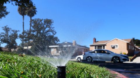 A sprinkler waters grass in Alhambra, California on September 23, 2021. - Water usage in Southern California has increased since July when Governor Gavin Newsom asked cities to conserve water usage by at least 15% due to California's worsening drought situation. (Photo by Frederic J. BROWN / AFP) (Photo by FREDERIC J. BROWN/AFP via Getty Images)