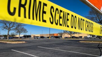Crime scene tape blocks the parking lot outside of a Walmart following a mass shooting the night before in Chesapeake, Virginia on November 23, 2022. - A gunman killed at least six people at a Walmart store Tuesday just ahead of the Thanksgiving holiday in the second mass shooting in the United States in four days. Police later identified the gunman as an employee at the store. (Photo by Bastien INZAURRALDE / AFP) (Photo by BASTIEN INZAURRALDE/AFP via Getty Images)