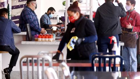 LOS ANGELES, CALIFORNIA - DECEMBER 15: People wear face coverings inside Grand Central Market on December 15, 2021 in Los Angeles, California. California residents, regardless of COVID-19 vaccination status, are required to wear face masks in all indoor public settings beginning today in response to rising coronavirus case numbers and the omicron threat. The statewide mandate will be in effect through January 15, 2022. (Photo by Mario Tama/Getty Images)