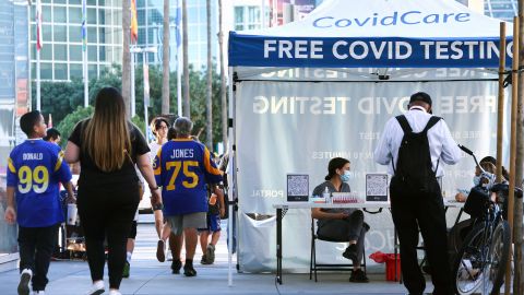 LOS ANGELES, CALIFORNIA - FEBRUARY 11: Rams fans walk past free Covid testing outside the Los Angeles Convention Center, site of the Super Bowl Experience, the NFL's 'interactive football theme park', ahead of Super Bowl LVI on February 11, 2022 in Los Angeles, California. Super Bowl LVI will be played on February 13 at SoFi Stadium in Inglewood, California, where the hometown Los Angeles Rams will face the Cincinnati Bengals. (Photo by Mario Tama/Getty Images)