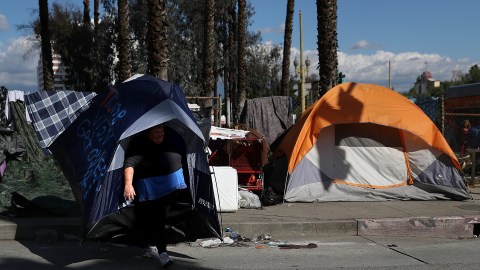 LOS ANGELES, CA - JANUARY 24: Lisa Rogers, a homeless woman, carries her tent as she relocates her camp on January 24, 2017 in Los Angeles, California. According to a 2016 report by the U.S. Department of Housing and Urban Development, Los Angeles has the highest number of homeless people in the nation with close to 13,000 living on the streets. The annual Greater Los Angeles Homeless Count begins today and will continue through Thursday. (Photo by Justin Sullivan/Getty Images)