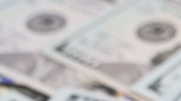 Imagen de fajos de billetes de dólares.