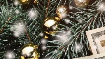 Imagen de varios rollos de billetes amarrados con lazos rojos y adornos de Navidad.