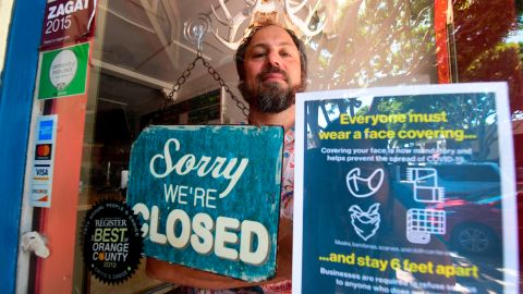 Gabriel Gordon stands behind the glass entrance door to his restaurant Beachwood BBQ, open for 14 years in Seal Beach, California on July 28, 2020, but closing soon due to the economic situation around the coronavirus pandemic. - For Gabriel Gordon and his wife Lena, the small restaurant they opened 14 years ago in the coastal California town of Seal Beach was a dream project and the cornerstone of their futur success. (Photo by Frederic J. BROWN / AFP) (Photo by FREDERIC J. BROWN/AFP via Getty Images)