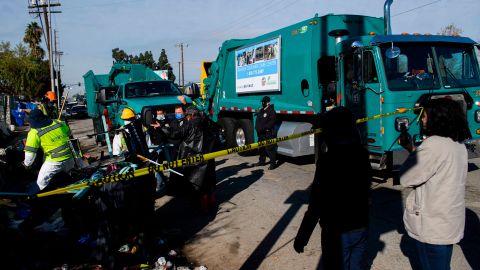 Activists with Services Not Sweeps record as a person experiencing homelessness tries to stop their possessions from being seized as Los Angeles City Bureau of Sanitation workers conduct a cleanup sweep of a homeless encampment during the Covid-19 pandemic on January 28, 2021 in the Harbor City neighborhood of Los Angeles. - Community activists with Services Not Sweeps monitored the cleanup after holding a car blockade to pressure the city workers to not remove tents, shelter, or belongings - only debris or trash - as unhoused people shelter in place per CDC guidance during the coronavirus pandemic. (Photo by Patrick T. FALLON / AFP) (Photo by PATRICK T. FALLON/AFP via Getty Images)