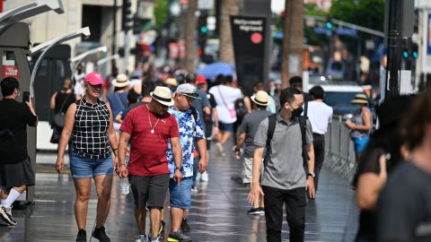 Tourists walk on Hollywood Boulevard's Walk of Fame, August 16, 2021 in Hollywood, California. - Tourism on Hollywood Boulevards has increased as much as 153% between April and June after a severe drop off during the early part of the Covid-19 pandemic, according to a report published in the Los Angeles Times on August 16, 2021. Business owners say theyre seeing a larger proportion of visitors from the U.S. over international tourists. (Photo by Robyn Beck / AFP) (Photo by ROBYN BECK/AFP via Getty Images)