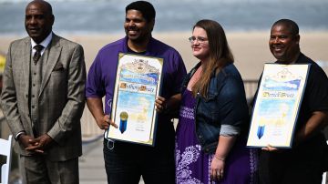 California State Senator Steven Bradford, Anthony Bruce, Sandra Bruce, and Derrick Bruce stand with LA County proclamations during a ceremony to return ownership of Bruce's Beach to the descendants of a Black family who had the land seized from them through eminent domain a century ago on July 20, 2022 in Manhattan Beach, California. - Los Angeles county officials returned the California beachfront property to the descendants of a Black family who had the land seized from them a century ago, in a move hailed as a step towards atoning for racial injustice. Willa and Charles Bruce purchased the land in 1912 and after adding a few other adjacent plots created a beach resort, which came to be known as Bruce's Beach, catering to Black residents, who had few options at the time for enjoying the California coast. (Photo by Patrick T. FALLON / AFP) (Photo by PATRICK T. FALLON/AFP via Getty Images)