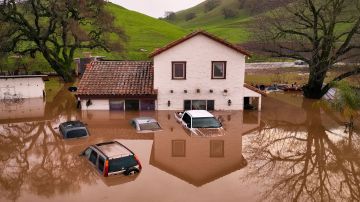 A flooded house is seen partially underwater in Gilroy, California, on January 09, 2023. - Heavy rain lashed water-logged California Monday, with forecasters warning of floods as a parade of storms that have killed 12 people battered the western United States. (Photo by JOSH EDELSON / AFP) (Photo by JOSH EDELSON/AFP via Getty Images)