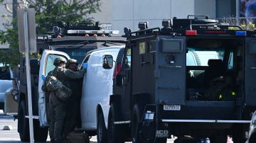 Law enforcement personnel open the door of a van outside the site in Torrance, California, where the alleged suspect in the mass shooting in which 10 people were killed in Monterey Park, California, is believed to be holed up on January 22, 2023. - Police were involved in a stand-off Sunday with a man they believe killed 10 people in a mass shooting at a dance club during Lunar New Year celebrations in California. At least 10 other people were wounded in the shooting with the gunman -- described by police as Asian -- firing indiscriminately at the club in Monterey Park, near Los Angeles, witnesses said. (Photo by Robyn BECK / AFP) (Photo by ROBYN BECK/AFP via Getty Images)