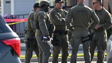 Los Angeles County Sheriff's Deputies gather after breaking into a van with a body in the driver's seat in Torrance, California, on January 22, 2023. - California police hunting the gunman who killed 10 people at a dance club during Lunar New Year celebrations broke into a van after a lengthy standoff Sunday, where images showed a body slumped in the driver's seat. The hunt began 12 hours earlier after a man -- described by police as Asian -- began firing at a club in Monterey Park, a city in Los Angeles County with a large Asian community. (Photo by Robyn BECK / AFP) (Photo by ROBYN BECK/AFP via Getty Images)